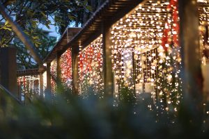 An enclosed porch covered in fairy lights